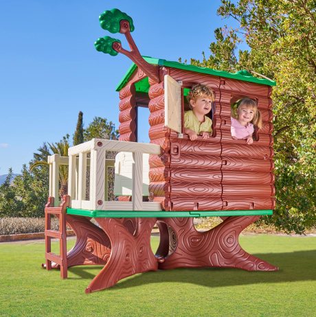 2 children peering out a plastic treehouse for children
